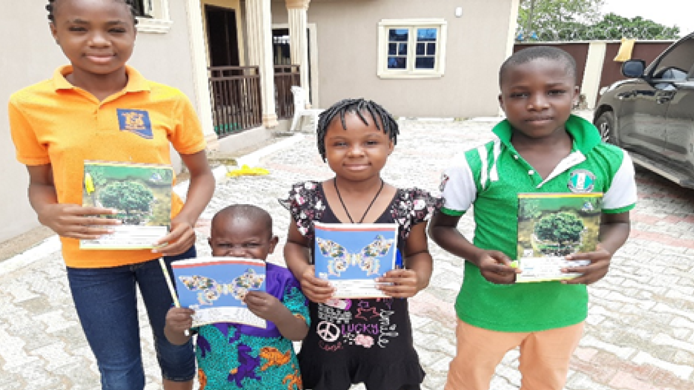 Some children with exercise books gifts